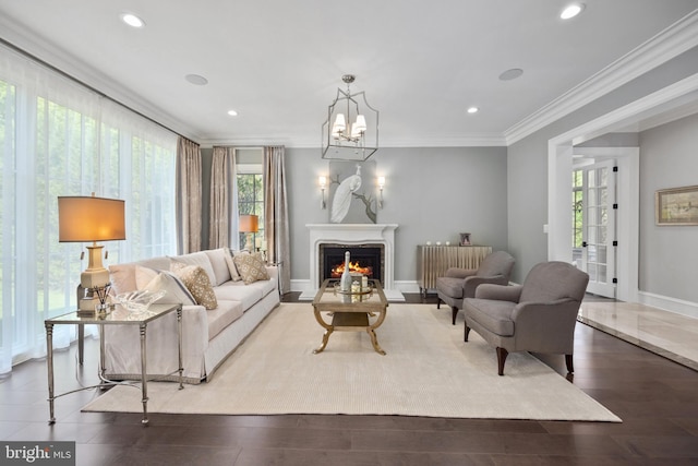 living room with ornamental molding, wood-type flooring, radiator heating unit, and a wealth of natural light