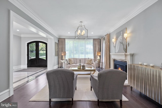 living room with a chandelier, crown molding, and dark hardwood / wood-style flooring