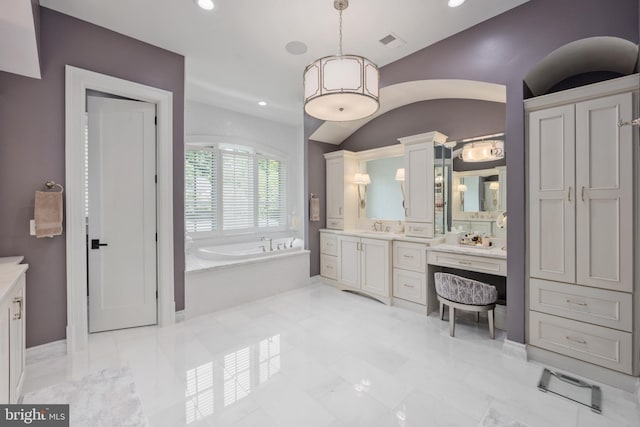 bathroom featuring tile flooring, vanity, and a bath to relax in