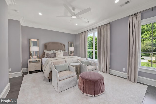 bedroom featuring ornamental molding, dark hardwood / wood-style flooring, and ceiling fan