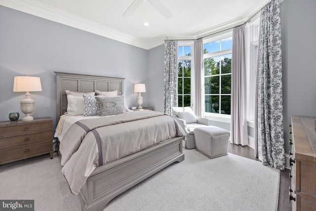 bedroom with wood-type flooring, ceiling fan, and crown molding