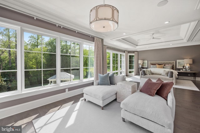 bedroom featuring multiple windows, crown molding, a tray ceiling, and dark hardwood / wood-style floors