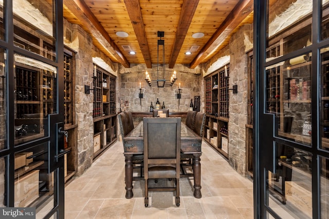 wine cellar featuring wooden ceiling, light tile floors, and beamed ceiling