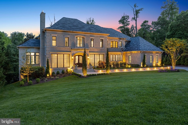 back house at dusk with a yard