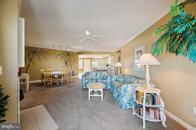 living room featuring ceiling fan, ornamental molding, carpet flooring, and rail lighting