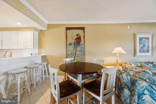 dining space with ornamental molding and light tile floors