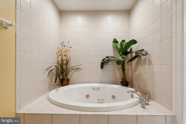 bathroom featuring tile walls and tiled tub