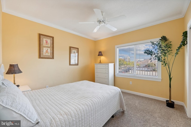 bedroom with ceiling fan, carpet floors, and crown molding