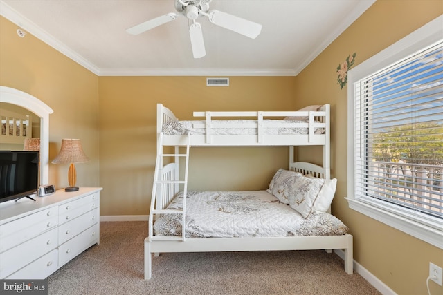 bedroom with carpet, ornamental molding, and ceiling fan