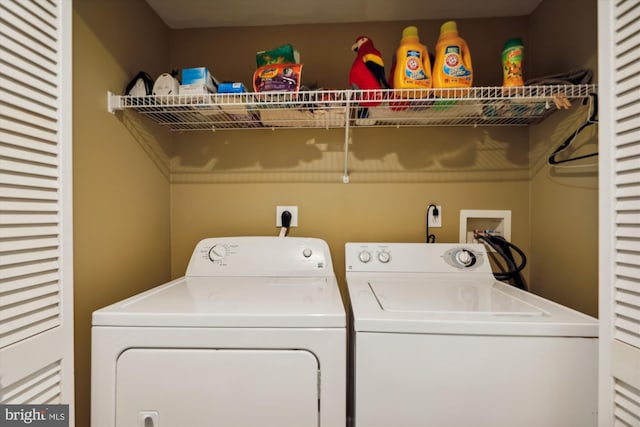 clothes washing area featuring hookup for a washing machine, hookup for an electric dryer, and independent washer and dryer