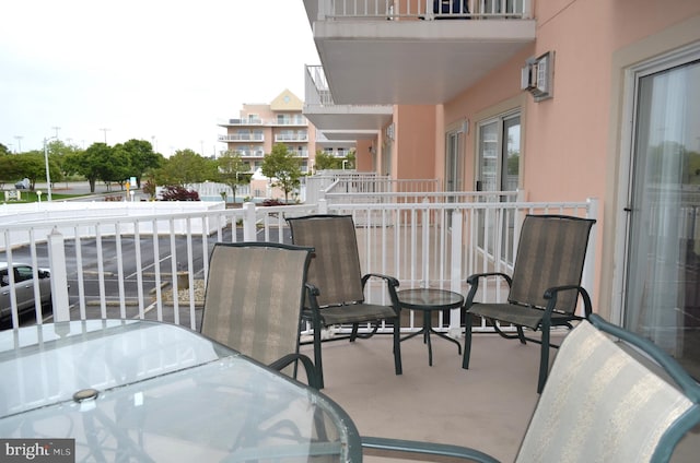 balcony featuring a wall unit AC