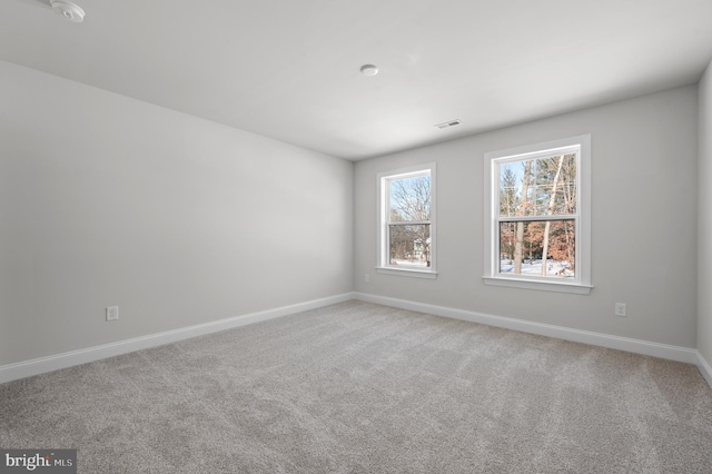 unfurnished room featuring carpet flooring