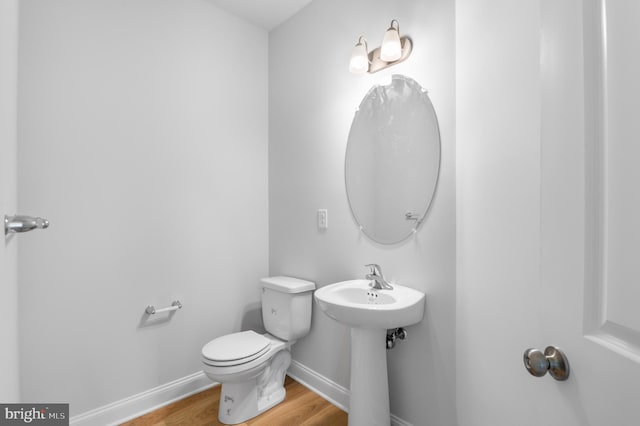 bathroom featuring sink, hardwood / wood-style flooring, and toilet