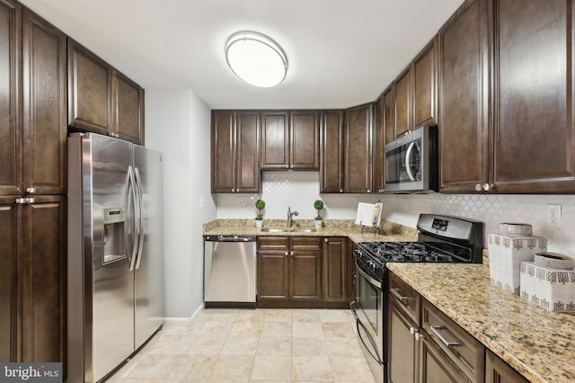 kitchen featuring dark brown cabinetry and appliances with stainless steel finishes