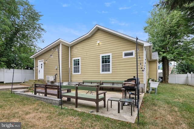 back of house featuring a yard