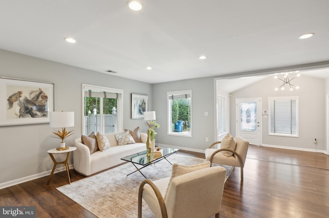 living room featuring a chandelier, dark hardwood / wood-style floors, and lofted ceiling