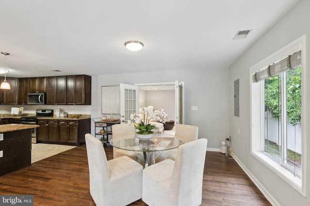 dining room with a healthy amount of sunlight and dark wood-type flooring