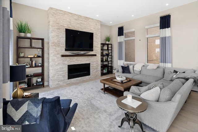 living room with a fireplace and light hardwood / wood-style floors