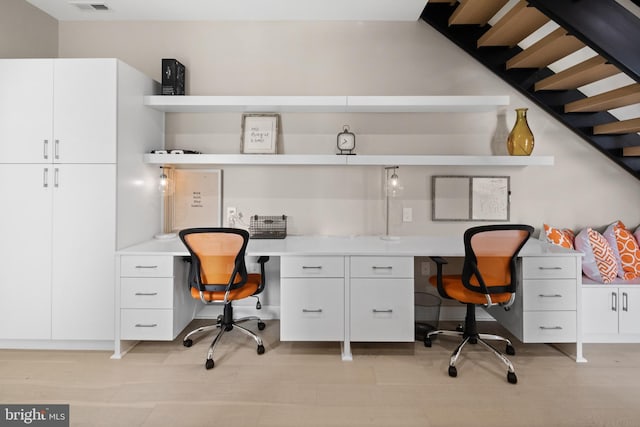 office area featuring built in desk and light wood-type flooring