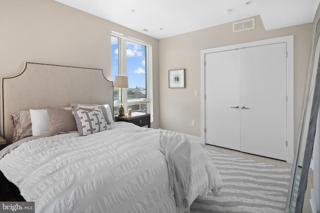 bedroom featuring light carpet and a closet