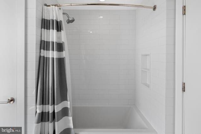 bathroom featuring shower / tub combo with curtain