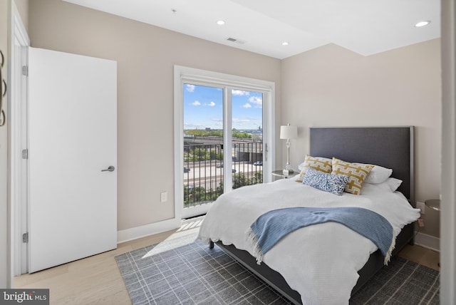 bedroom featuring access to outside and wood-type flooring