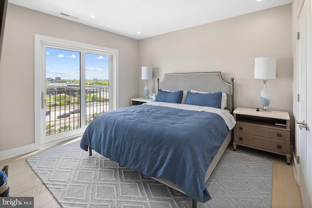 bedroom featuring access to outside and light wood-type flooring