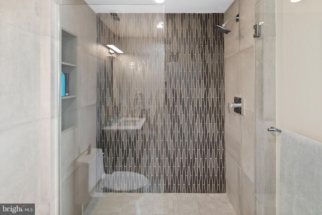 bathroom with a tile shower