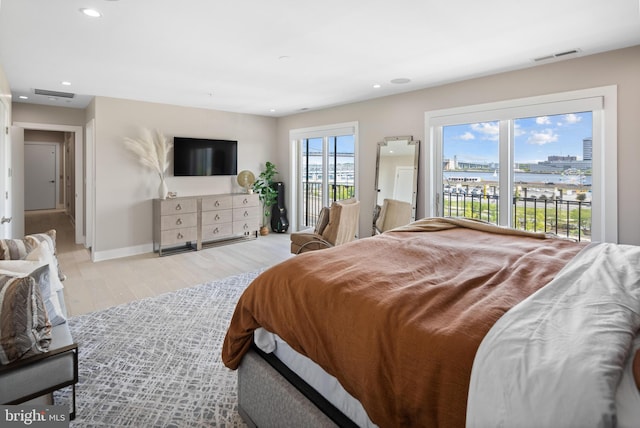 bedroom with access to outside and light wood-type flooring