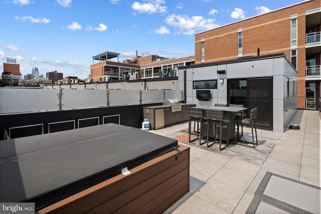 exterior space with grilling area and a jacuzzi