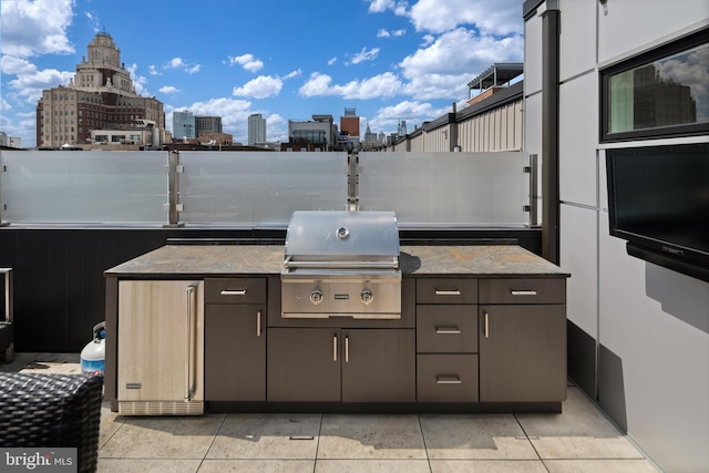 view of patio with area for grilling and a grill