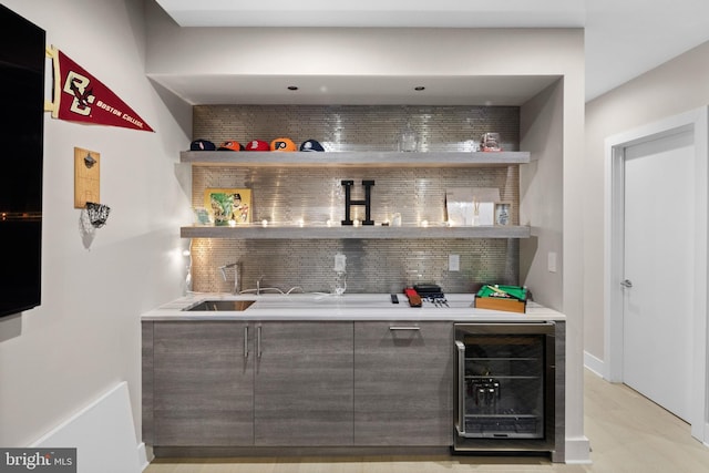 bar featuring dark brown cabinetry, tasteful backsplash, and beverage cooler