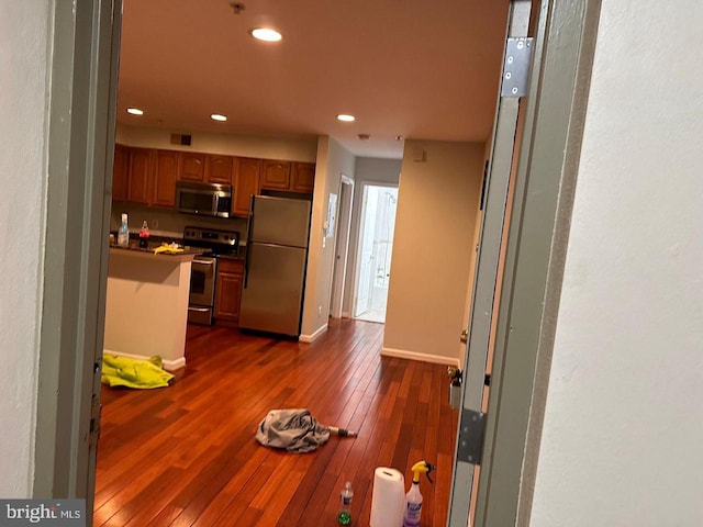 kitchen featuring appliances with stainless steel finishes and dark wood-type flooring