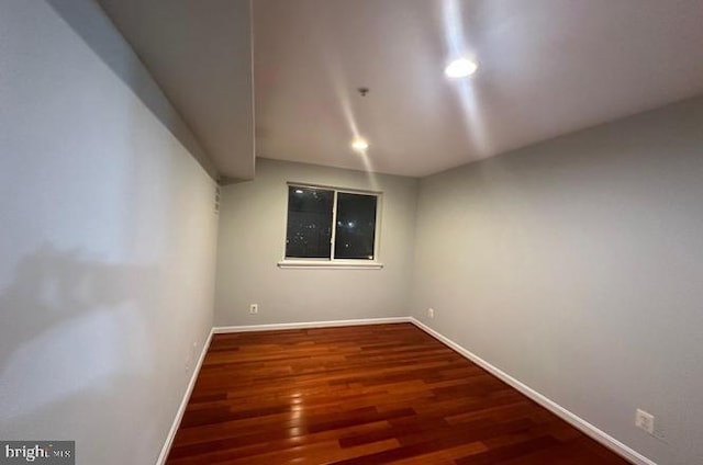 spare room with dark wood-type flooring