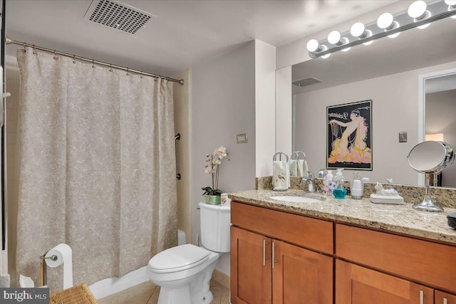 bathroom with tile flooring, toilet, and large vanity