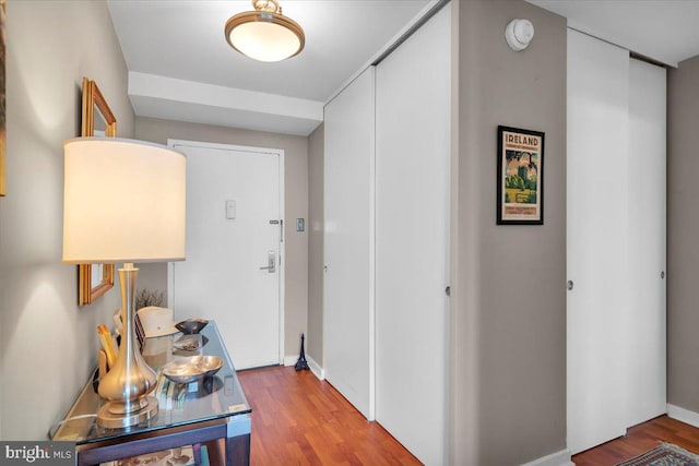 corridor with hardwood / wood-style floors