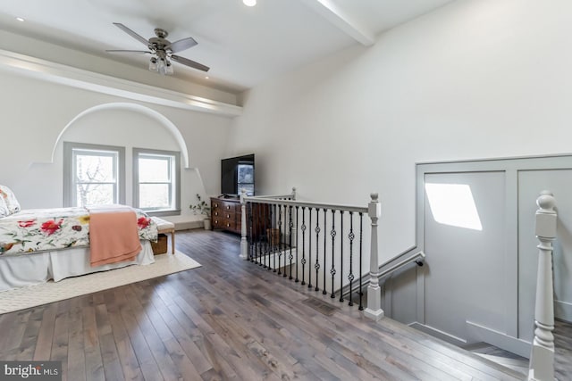 foyer entrance featuring beamed ceiling, dark wood-type flooring, and ceiling fan