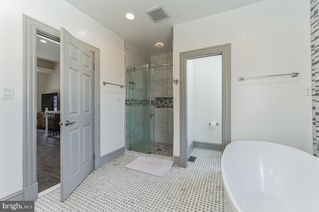 bathroom featuring tile flooring and shower with separate bathtub