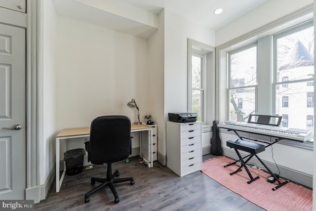 office area with hardwood / wood-style flooring and a healthy amount of sunlight