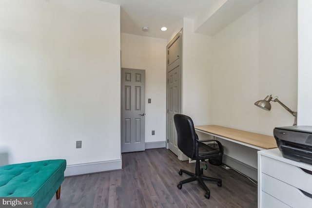 home office with dark hardwood / wood-style flooring