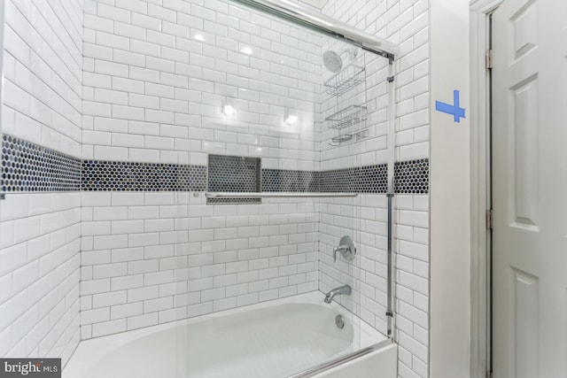 bathroom with shower / bath combination with glass door