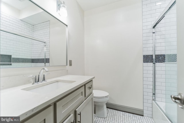 full bathroom with enclosed tub / shower combo, toilet, tile floors, and vanity