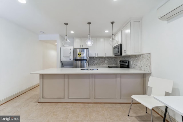 kitchen with a wall mounted air conditioner, white cabinetry, appliances with stainless steel finishes, light tile floors, and stacked washer and dryer