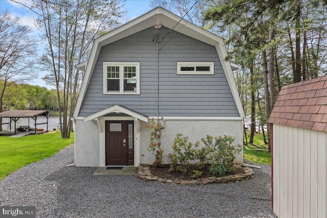 view of front of property with a gazebo and a shed