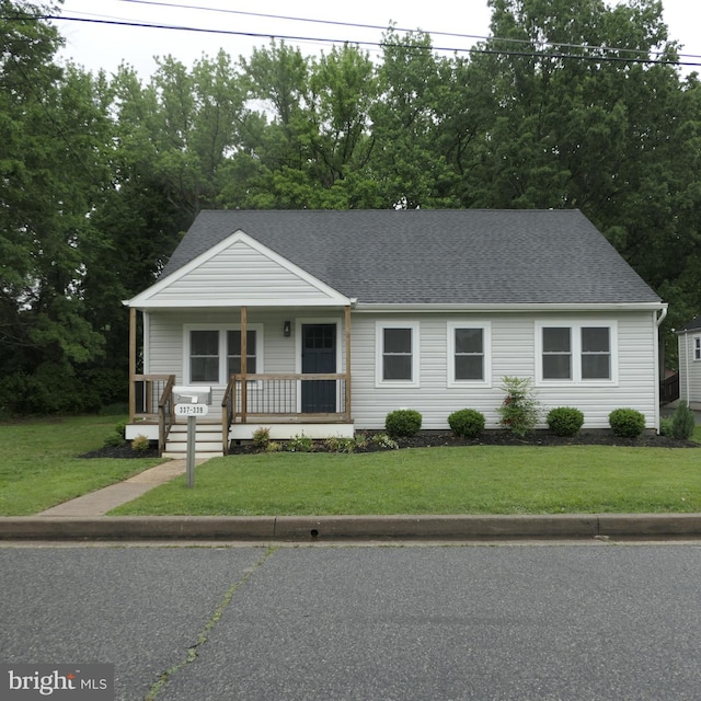 view of front of home with covered porch and a front yard