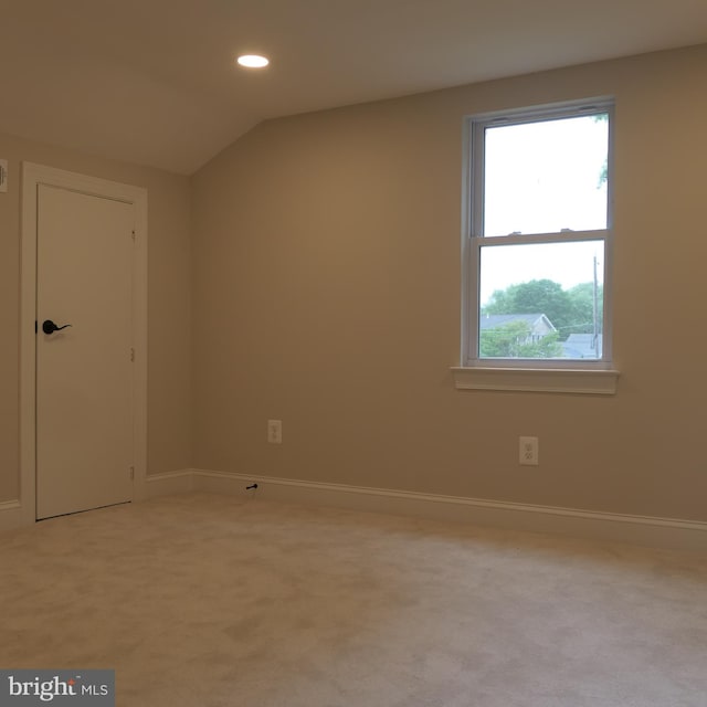 bonus room featuring light colored carpet and vaulted ceiling