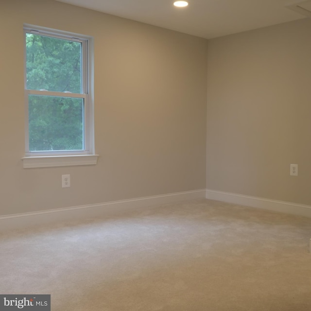 spare room with carpet floors and a healthy amount of sunlight