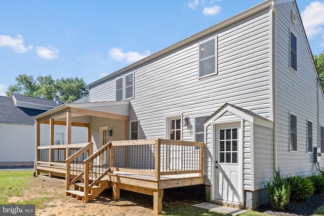 back of property featuring a wooden deck