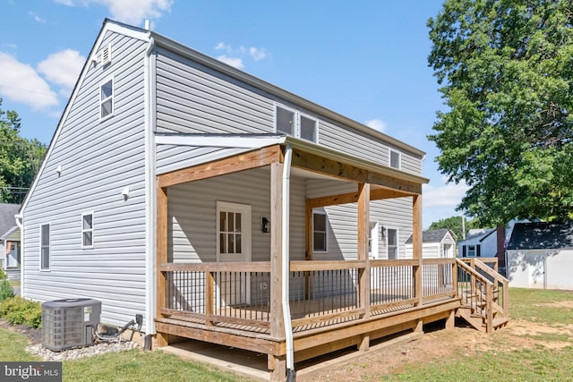 rear view of house with cooling unit and a deck