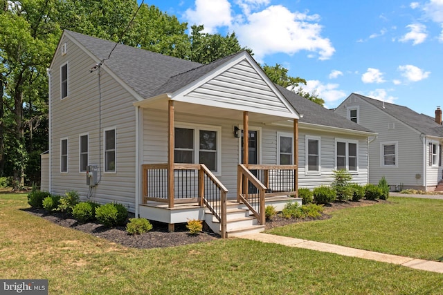 view of front of property with a front yard and covered porch